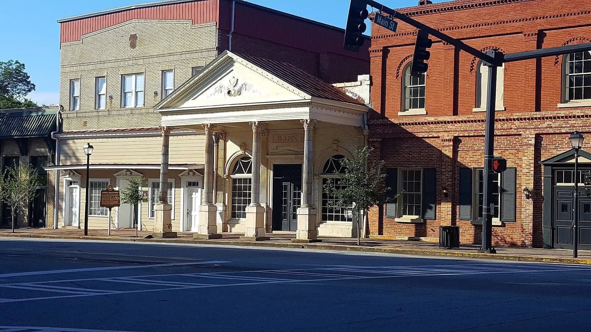 Historic brick and stucco commercial buildings on North Main Street in Madison, Georgia.